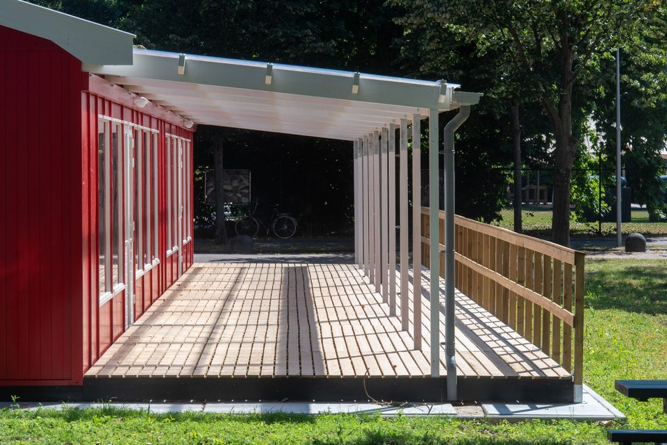 Patio with a transparent roof beside a building. Style example, not an Arc Signage Co project.
