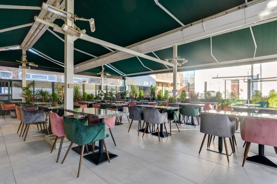 Restaurant dining under a tented cover. Style example, not an Arc Signage Co project.