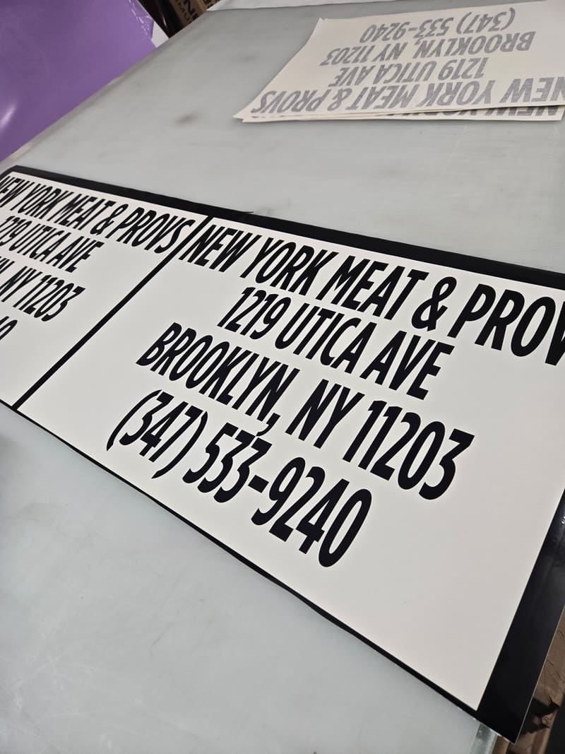Storefront decal panels laid out for fabrication.